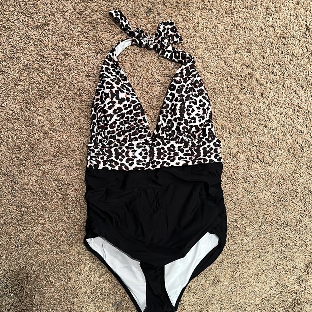 Swimsuit. One piece. Halter tie around neck. Animal print on top.Black on bottom